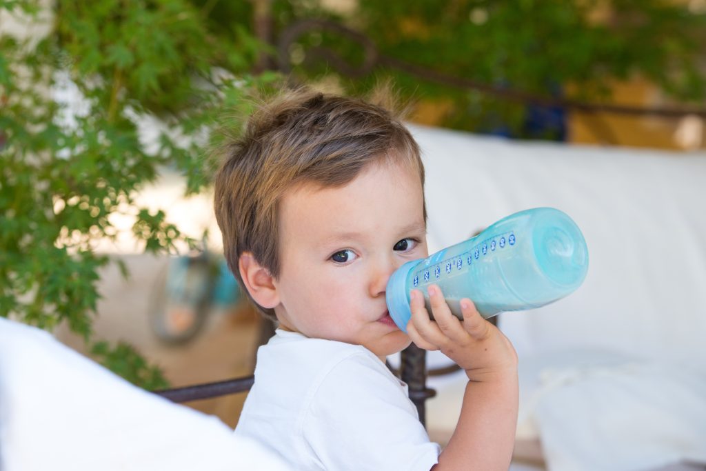 bébé qui boit un biberon de lait